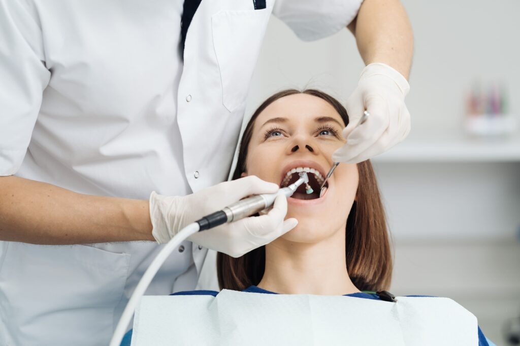 WOman on a dentist chair getting her teeth checked