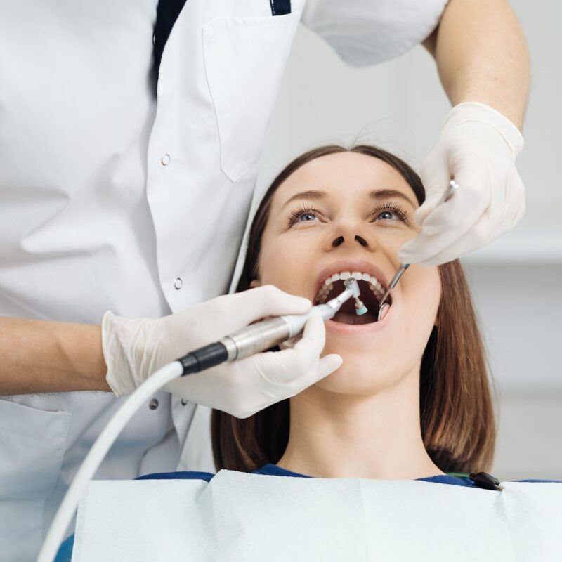 WOman on a dentist chair getting her teeth checked